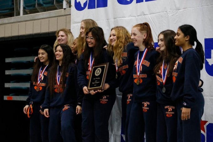 The Seven Lakes girls wrestling team celebrates after winning the team title at the District 9-6A meet