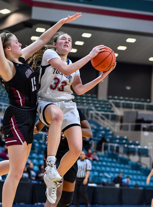 Katy Tx. Feb 15, 2022: Tompkins Macy Spencer #33 goes up for the shot guarded by George Ranch's Lauren Stevens #15 in overtime scoring for the Falcons during the Bi-District playoff, Tompkins vs George Ranch. (Photo by Mark Goodman / Katy Times)