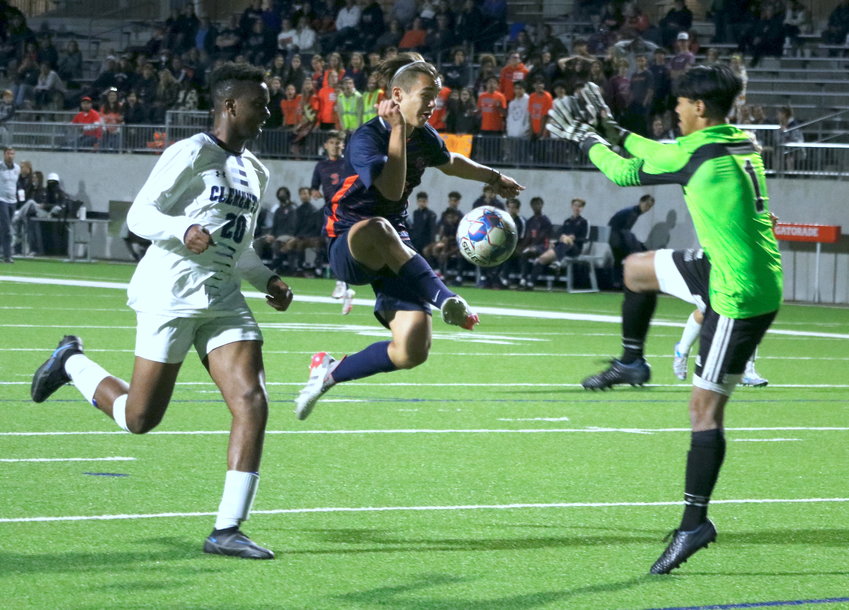 Kortay Koc jumps to try and volley a ball towards goal during Thursday&rsquo;s Class 6A bi-district game between Seven Lakes and Fort Bend Clements at Legacy Stadium.