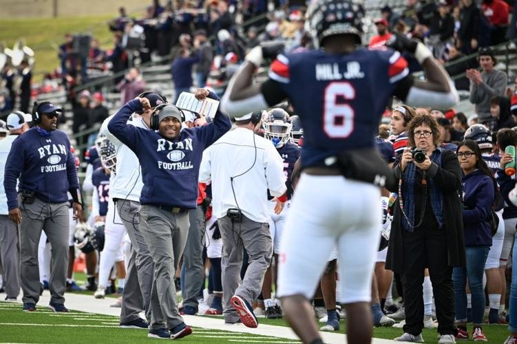 Denton Ryan offensive coordinator Lonnie Teagle flexes his muscles with Anthony Hill Jr. after Hill scored a touchdown against Longview at Mesquite Memorial Stadium. Teagle was named Paetow&rsquo;s head football coach on Wednesday.