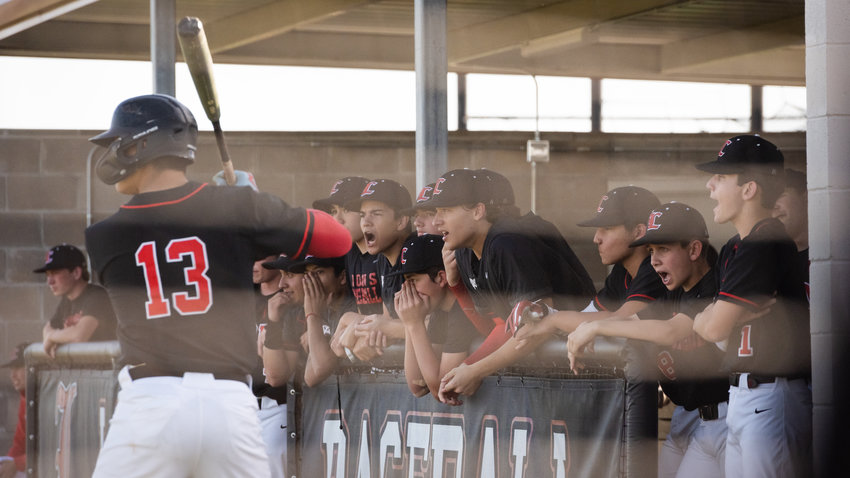 The St. Johns XXIII dugout looks on during a game