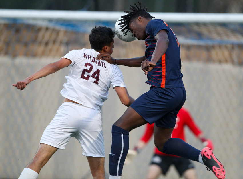 Seven Lakes forward Daniel Ejerenwa (11) heads the ball toward goal while working against Plano midfielder Cristian Cifuentes (24) during the Class 6A boys state semifinal between Katy Seven Lakes and Plano on April 15, 2022 in Georgetown, Texas.