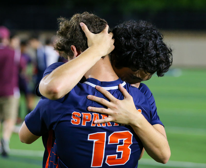 Seven Lakes players take a moment to console one another after a 3-2 loss to Plano in the Class 6A boys state semifinal on April 15, 2022 in Georgetown, Texas.