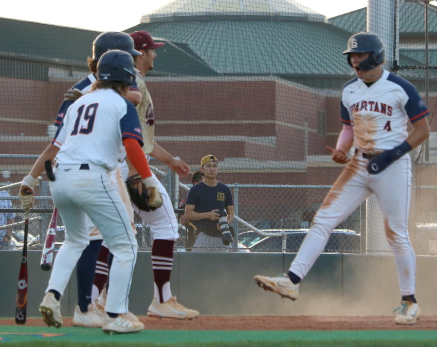 Cade Climie celebrates scoring a run during Friday&rsquo;s District 19-6A  game between Seven Lakes and Cinco Ranch at the Seven Lakes baseball field.