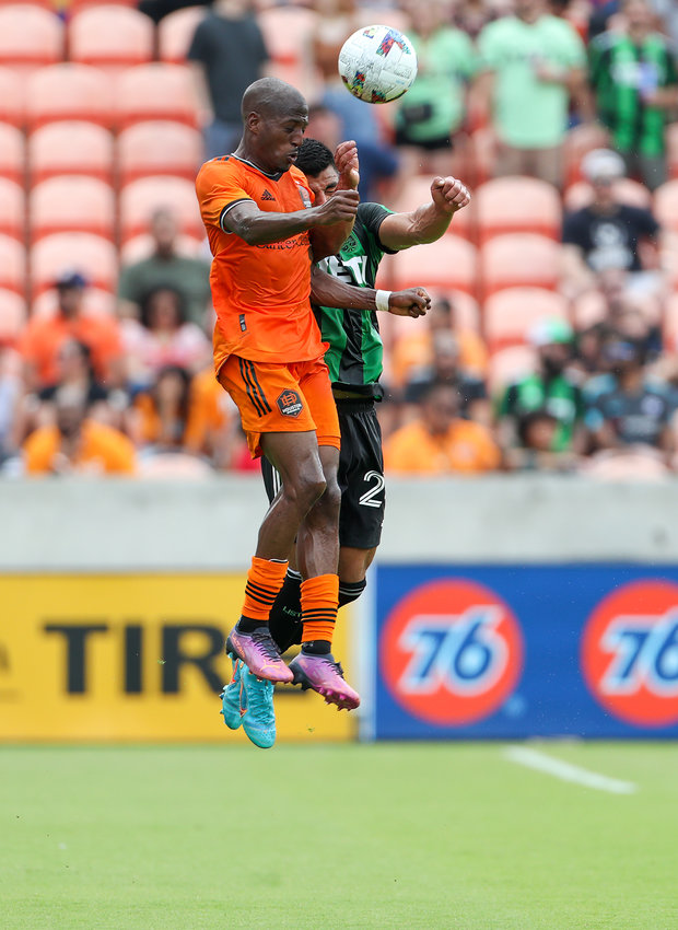 Houston Dynamo midfielder Faf&agrave; Picault (10) leaps to head the ball over Austin FC defender Nick Lima (24) during the first half of a Major League Soccer match on April 30, 2022 in Houston, Texas.