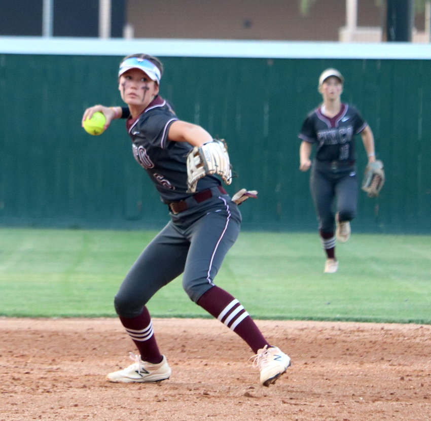 Faith Piper throws a ball to first base during an area round game between Cinco Ranch and Heights at Memorial High School