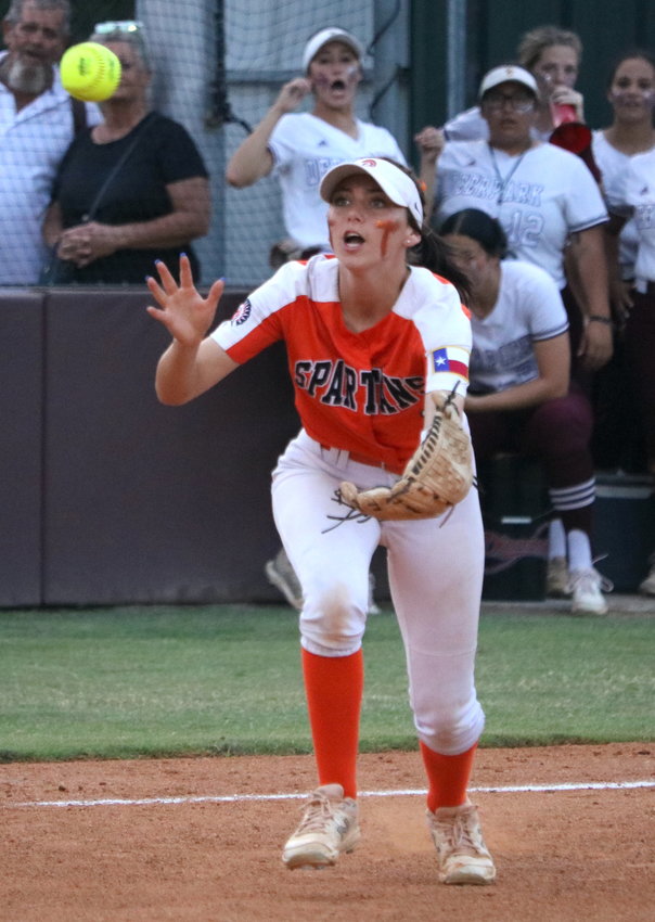 Kamryn Wallman reaches to catch a fly ball during Friday&rsquo;s Class 6A Regional Semifinal between Seven Lakes and Deer Park at the Summer Creek softball field.