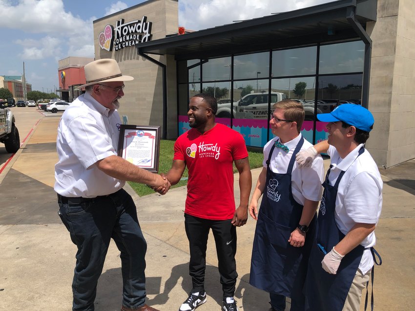 Harris County Pet. 4 Commissioner Jack Cagle, left, awards a proclamation to Howdy Homemade Ice Cream shop owner Roderick Batson, Austin Hanson and Andrew Heap. The store refers to its employees as &ldquo;heroes.&rdquo;