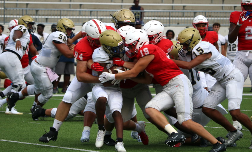 Katy&rsquo;s defense makes a stop during Katy&rsquo;s scrimmage against Klein Collins on Friday at Legacy Stadium.