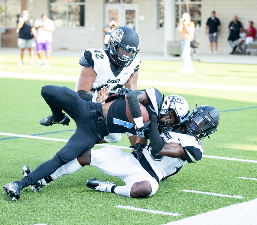 Paetow Derrick Johnson runs over a defender during Friday&rsquo;s game against Conroe at Legacy Stadium.