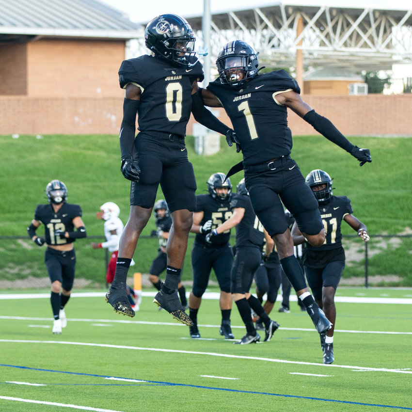 Jordan&rsquo;s Zechariah Sample and Zion Jones celebrate after Sample scored a touchdown on an interception during Saturday&rsquo;s game between Jordan and Aldine Davis.