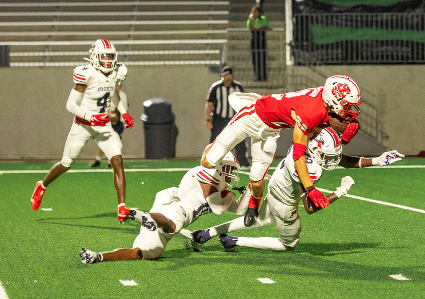 Katy&rsquo;s Adam Jackson dives over Atascocita defenders to score a touchdown during Friday&rsquo;s game between Katy and Atascocita at Legacy Stadium.