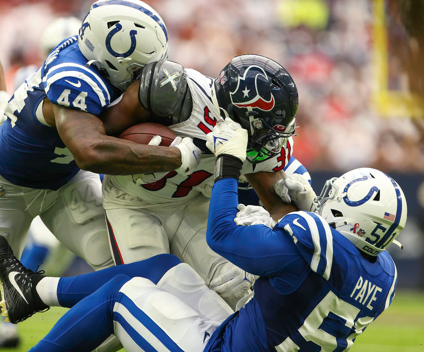 Indianapolis Colts linebacker Zaire Franklin (44) and defensive end Kwity Paye (51) wrap up and tackle Houston Texans running back Dameon Pierce (31) on a carry during an NFL game between the Texans and the Colts on September 11, 2022 in Houston. The game ended in a 20-20 tie after a scoreless overtime period.