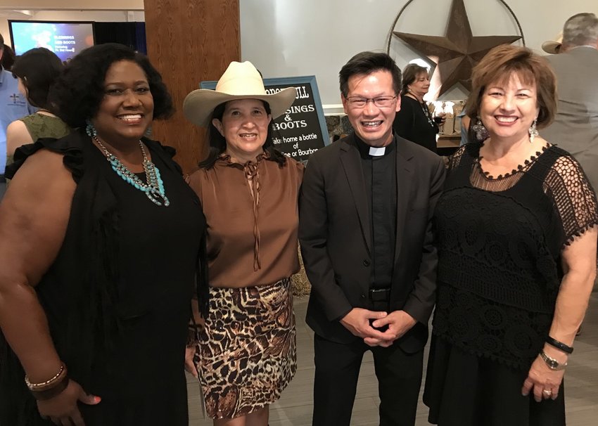 Mamie George Community Center Executive Director Gladys Brumfield-James, event co-chair Elilah Cavazos, Father Dat Hoang and event chair Elsa Poole prepare to kick up their heels at the &ldquo;Boots and Blessings&rdquo;-themed Mission of Love gala.