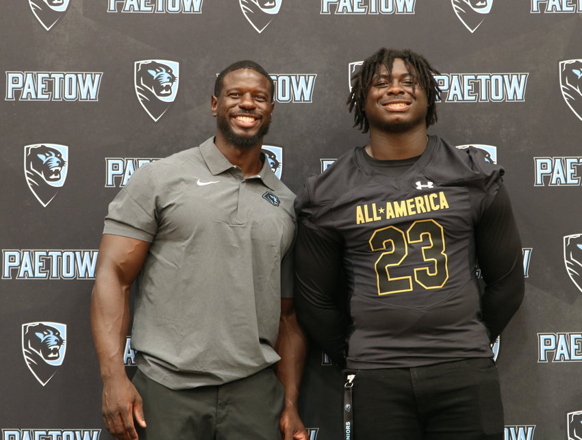 DJ Hicks and David Hicks Sr. pose for a photo after DJ Hicks received his Under Armour All-American jersey at the Paetow gym on Friday.