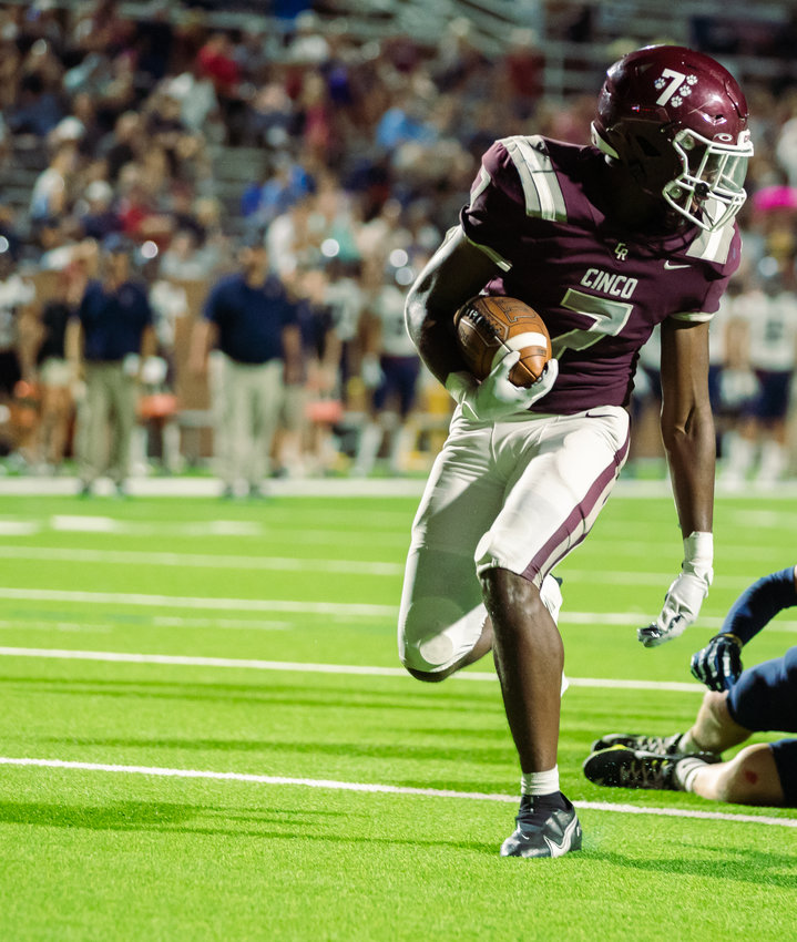 Cinco Ranch&rsquo;s Sam McKnight runs into the endzone during a game between Cinco Ranch and Tompkins at Rhodes Stadium.
