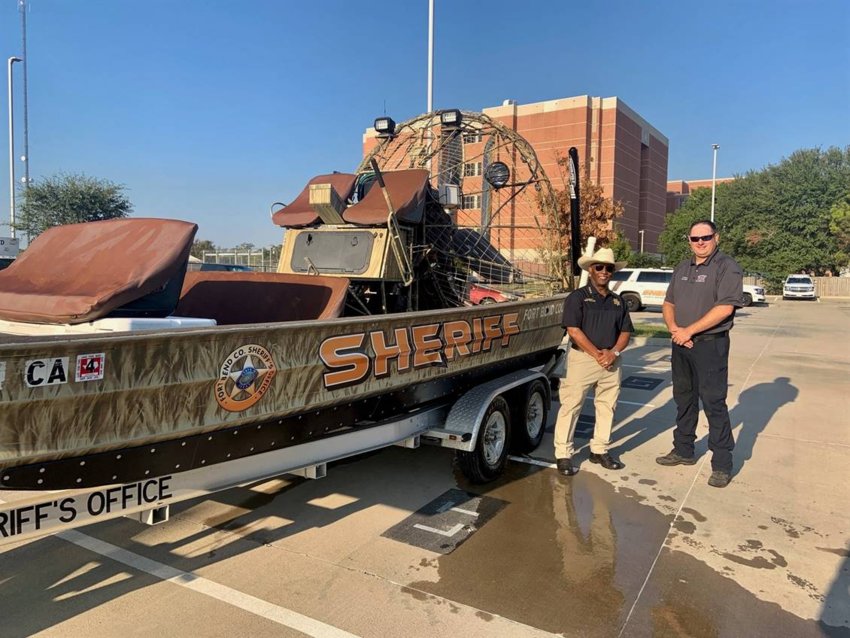 Fort Bend County Sheriff Eric Fagan and Northeast Fort Bend County Fire Chief Travis Baxter pause for a snapshot with the sheriff&rsquo;s office airboat.