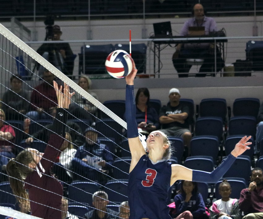 Presley Powell tips a ball over the net during Saturday&rsquo;s Class 6A-Region III Final against Cinco Ranch at Delmar Fieldhouse.