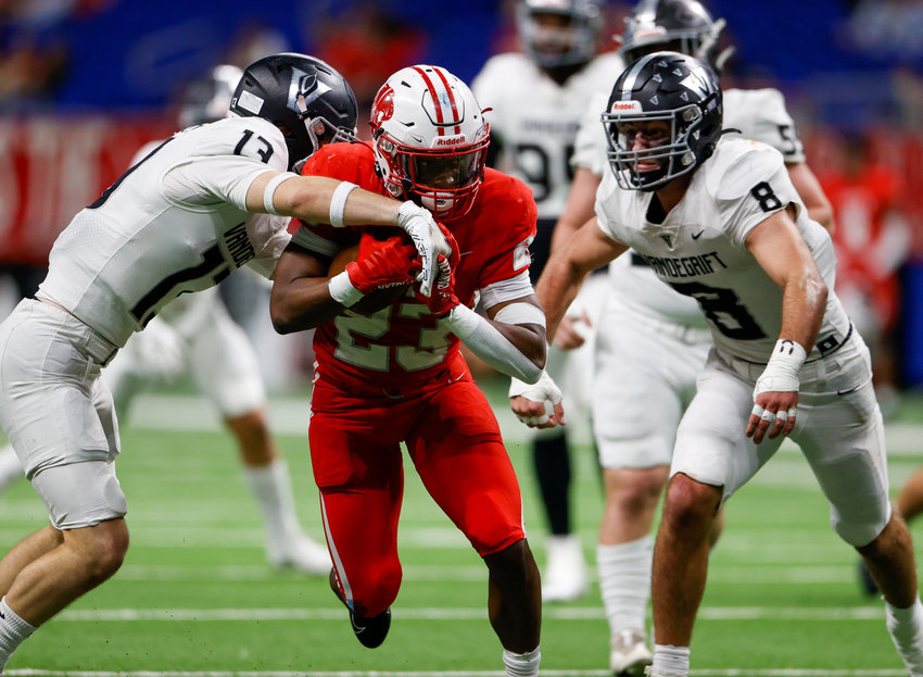 Vandegrift Vipers senior defensive back Davis Scott (13) works to bring down Katy running back Seth Davis (23) during the Class 6A-DII state semifinal football game between Katy and Vandegrift on Dec. 10, 2022 in San Antonio.