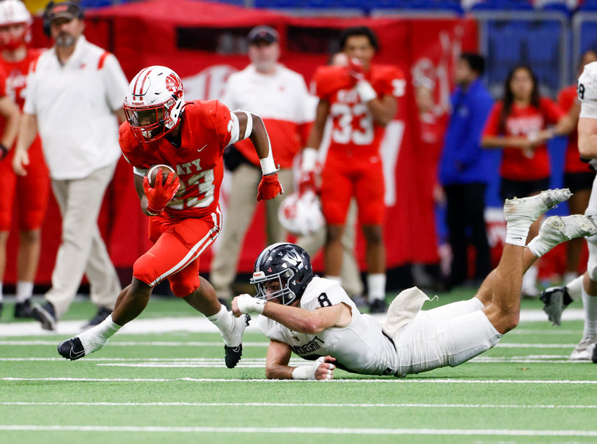 Katy running back Seth Davis (23) breaks a tackle by Vandegrift Vipers junior defensive back Alex Foster (8) to score on a 49-yard touchdown run during the Class 6A-DII state semifinal football game between Katy and Vandegrift on Dec. 10, 2022 in San Antonio.