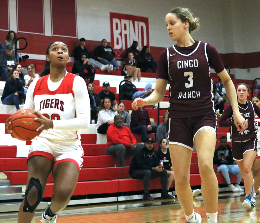 Lyric Barr drives past a defender during Tuesday&rsquo;s game between Katy and Cinco Ranch at the Katy gym.