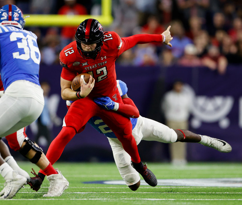 Texas Tech quarterback Tyler Shough (12) carries the ball for a first down during the TaxAct Texas Bowl on Dec. 28, 2022 in Houston.