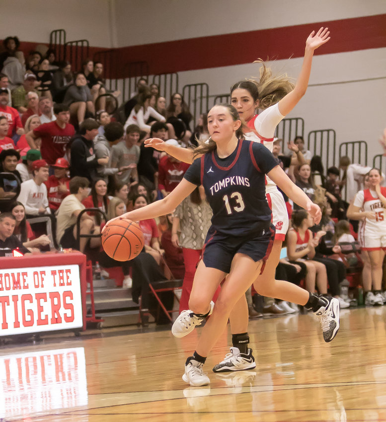 Macy Spencer dribbles past a defender during Tuesday's game between Katy and Tompkins at the Katy gym.