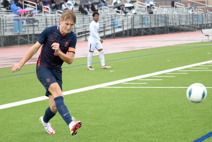 Hunter Merritt crosses a ball during Saturday's game between Seven Lakes and Mayde Creek at the Seven Lakes soccer field.