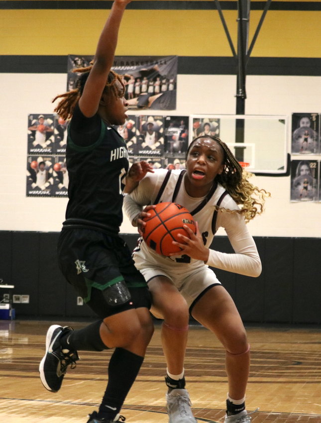 Aniya Foy battles through contact during Monday&rsquo;s Class 6A Bi-District playoff game between Cinco Ranch and Hightower at the Jordan gym.