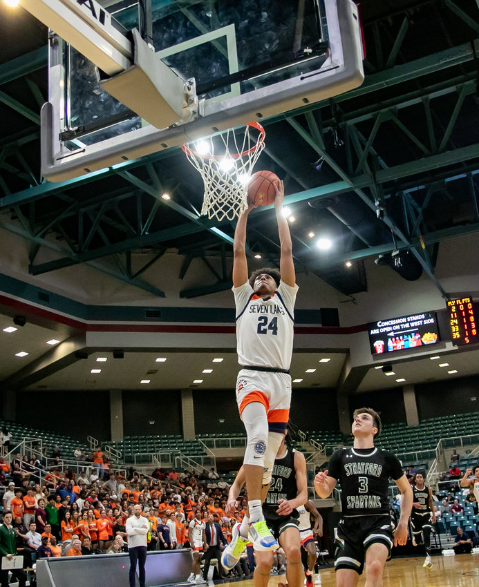 AJ Bates goes up for a dunk during Monday's Class 6A Regional Quarterfinal between Seven Lakes and Stratford at the Merrell Center.