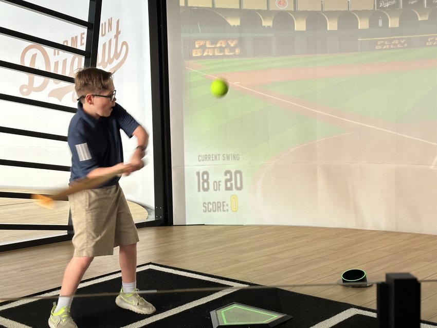 Landon Woolsey of Katy swings for the fences&mdash;albeit a virtual one&mdash;March 30 at the opening of Home Run Dugout in Katy, 1220 Grand West Blvd.