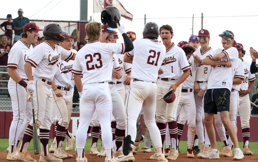 Charlie Atkinson celebrates with the rest of the Cinco Ranch players after hitting a home run during Tuesday's District 19-6A game between Cinco Ranch and Seven Lakes at the Cinco Ranch baseball field.