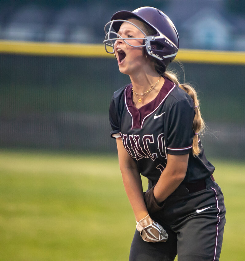 Sophie Hassall celebrates after a hit during Friday's area round game between Cinco Ranch and Heights at the Cinco Ranch softball field.