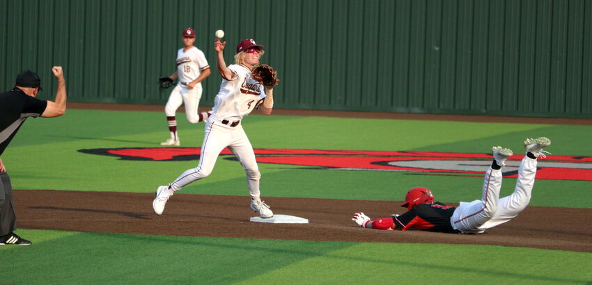Brock DeYoung throws to first base during Thursday's area round game between Cinco Ranch and Memorial at Cy-Lakes.