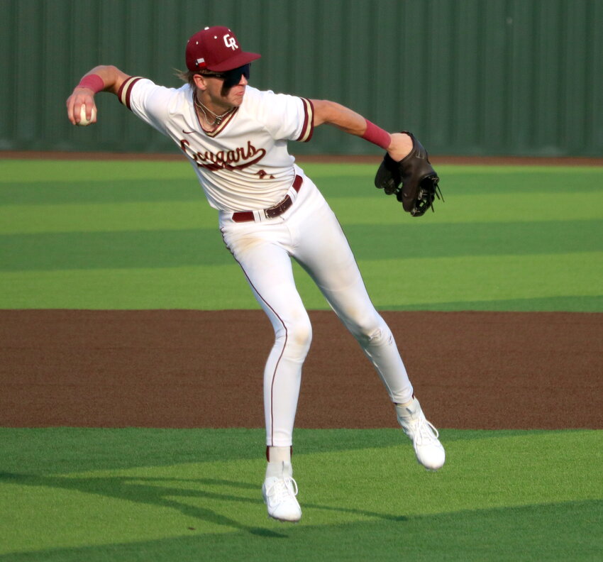 Lucas Franco throws to first base during Thursday's area round game between Cinco Ranch and Memorial at Cy-Lakes.