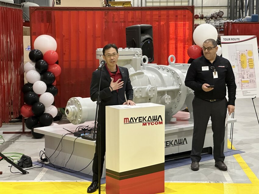 Tomo Hashimoto, CEO of Mayekawa USA, speaks at the company&rsquo;s open house in Katy. Majed Abdeljawad, vice president of manufacturing, is at right.