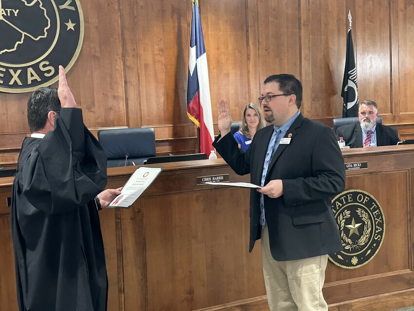 Katy City Council Member-at-Large Chris Harris takes the oath of office from Municipal Judge Jeffrey Brashear May 17 at City Hall.