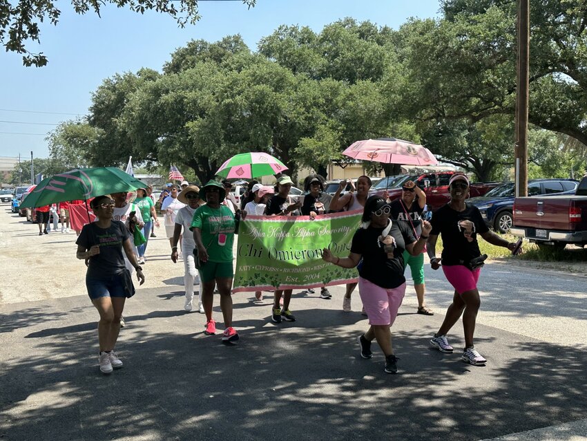 Members of the Chi Omicron Omega chapter of the Alpha Kappa Alpha sorority march in the first-ever Juneteenth Parade held June 19 at Katy Woodsland Park.