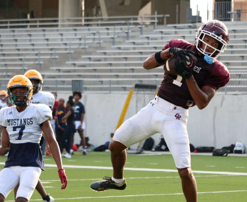 Taytum Johnson catches a touchdown pass during Cinco Ranch&rsquo;s scrimmage against Cy-Ranch at Legacy Stadium.
