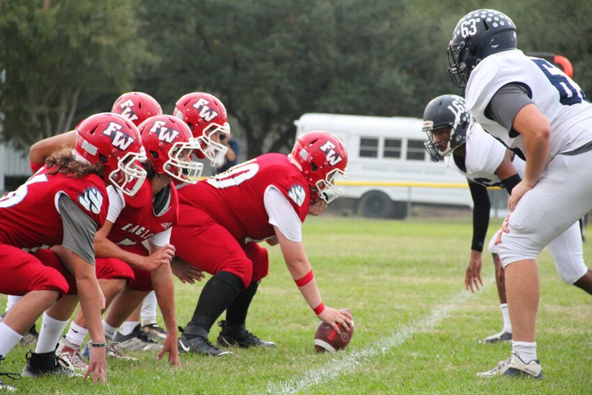 Faith West players line up for a snap during a game last season.