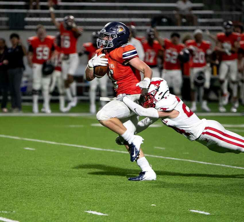 Barrett Hudson is brought down by a defender during Thursday's game between Seven Lakes and Memorial at Legacy Stadium.