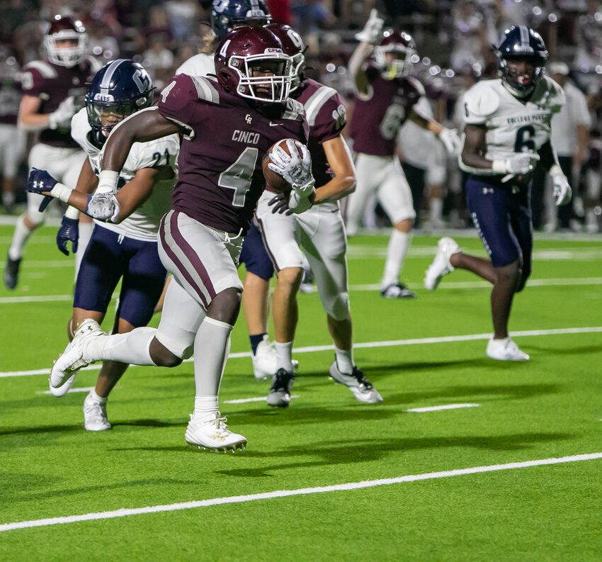 Tessiah Yong runs in for a touchdown during Friday's game between Cinco Ranch and College Park at Rhodes Stadium.