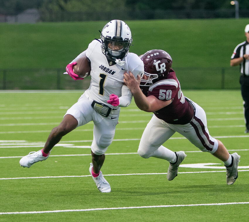 Zechariah Sample gets outside of a defender during a game between Jordan and Cinco Ranch at Rhodes Stadium.