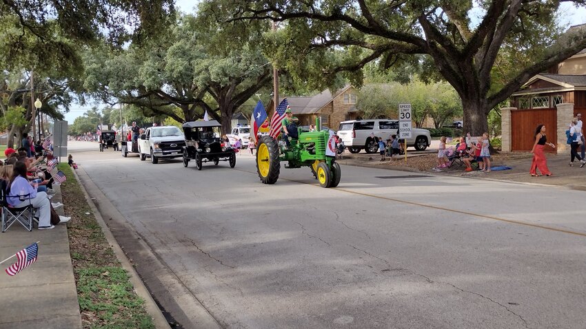 Katy City Administrator Byron Hebert is driving the John Deere tractor. Katy High School was among the schools marching in the parade.