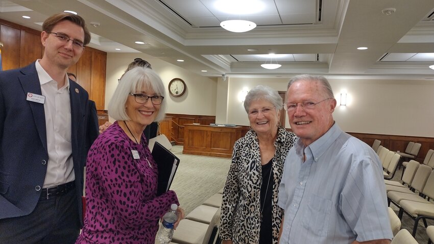 Council members Dan Smith (left) and Janet Corte confer with Sandy Schmidt and Bill Bain following Monday night's city council meeting. Both Schmidt and Bain spoke during the public comments portion of the meeting, favoring the proposal for the city to acquire land on Second Street for parking for downtown events.