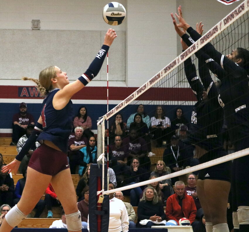 Callie Funk tips the ball over the net during Tuesday&rsquo;s match between Tompkins and George Ranch at the Tompkins gym.