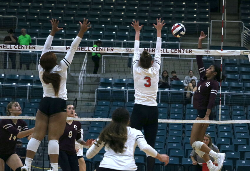 Gabi Martinez spikes the ball during Tuesday&rsquo;s bi-district match between Cinco Ranch and Fort Bend Travis at the Merrell Center.