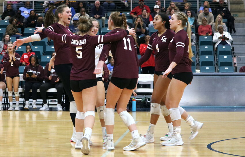 Cinco Ranch players celebrate after winning a set during Tuesday&rsquo;s bi-district match between Cinco Ranch and Fort Bend Travis at the Merrell Center.