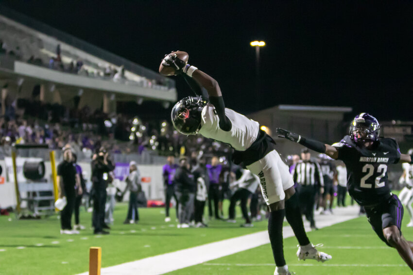 Andrew Marsh leaps to make a catch during Thursday's game between Jordan and Morton Ranch at Legacy Stadium.