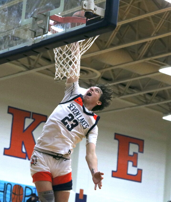 Brett Norton dunks the ball during Monday's game between Seven Lakes and Pearland Dawson at the Seven Lakes gym.